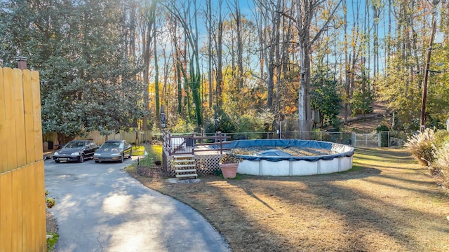 view of yard with a swimming pool side deck