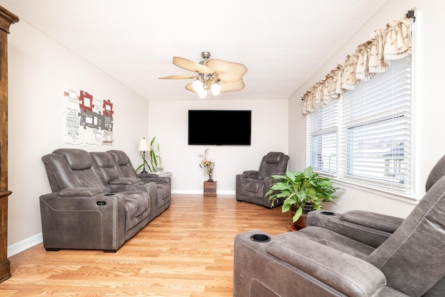 living room with hardwood / wood-style flooring and ceiling fan