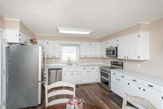 kitchen with stainless steel appliances, sink, white cabinets, and a textured ceiling