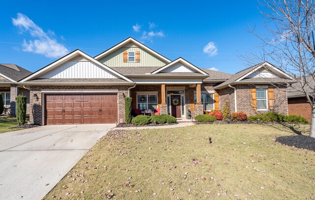 craftsman-style house featuring a front yard and a garage