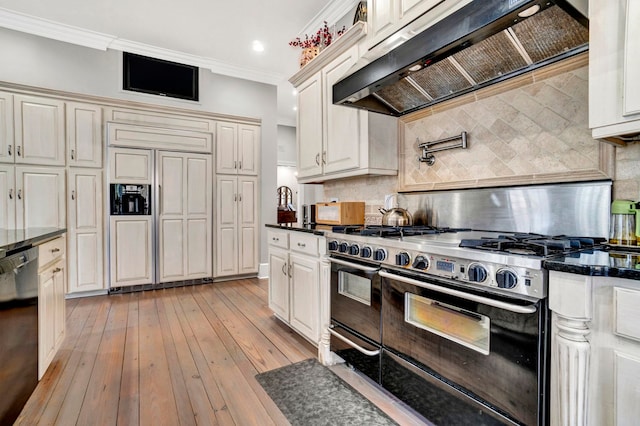 kitchen with premium appliances, tasteful backsplash, crown molding, exhaust hood, and light wood-type flooring