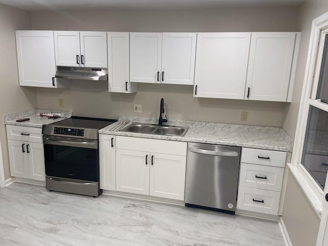 kitchen featuring white cabinets, sink, light stone countertops, and stainless steel appliances