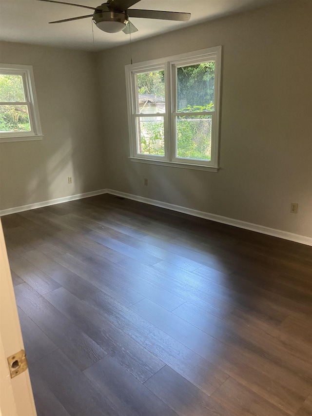 unfurnished room featuring dark hardwood / wood-style floors and ceiling fan