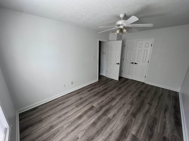 unfurnished bedroom featuring a textured ceiling, ceiling fan, a closet, and dark hardwood / wood-style floors