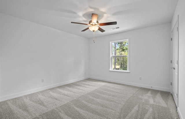 carpeted spare room with ceiling fan