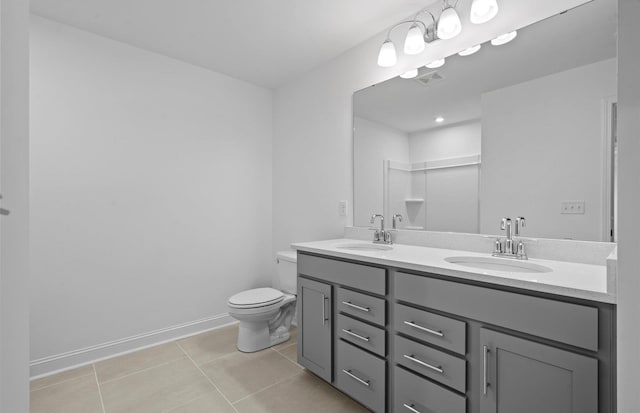 bathroom with toilet, tile patterned flooring, and vanity