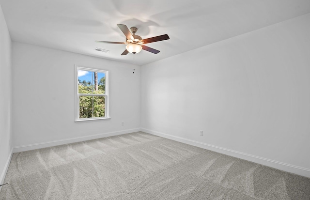 spare room featuring ceiling fan and light colored carpet