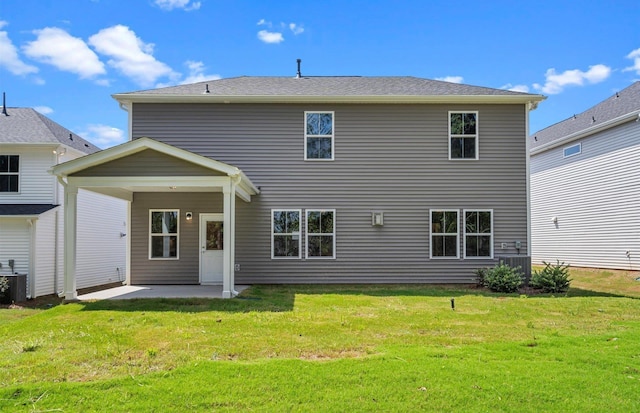 rear view of house with a patio area, central AC, and a lawn