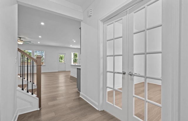 hallway featuring french doors and light hardwood / wood-style flooring