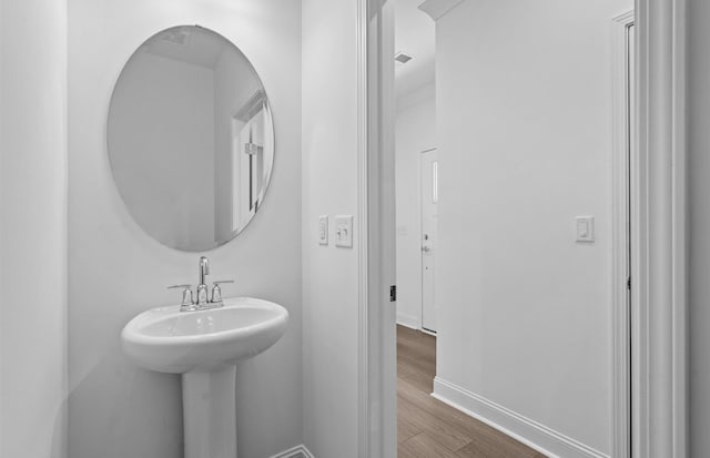 bathroom with sink and hardwood / wood-style flooring