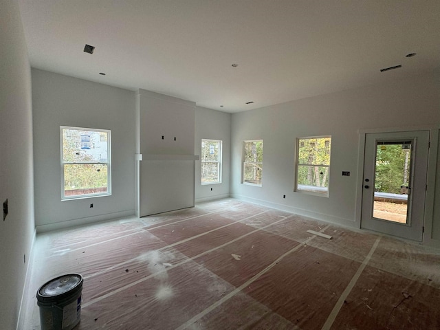 unfurnished living room featuring a wealth of natural light