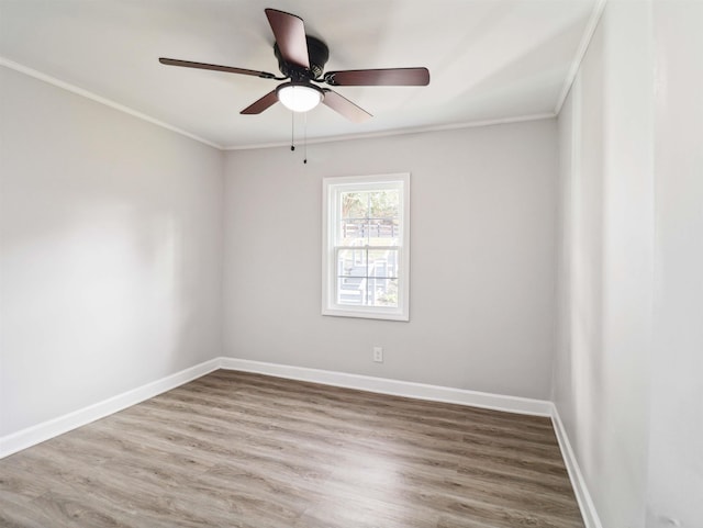 spare room with hardwood / wood-style flooring, ceiling fan, and crown molding