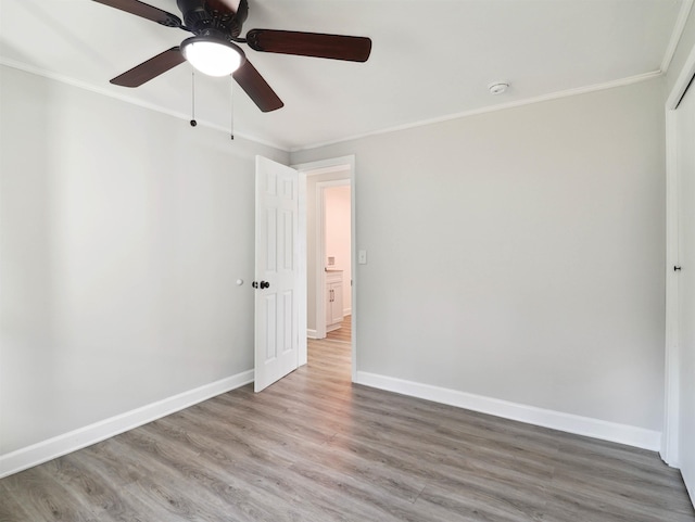 unfurnished room featuring crown molding, ceiling fan, and wood-type flooring