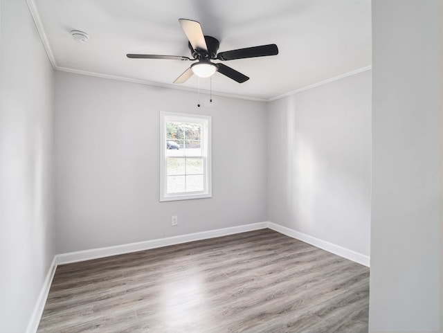 spare room featuring wood-type flooring and ornamental molding