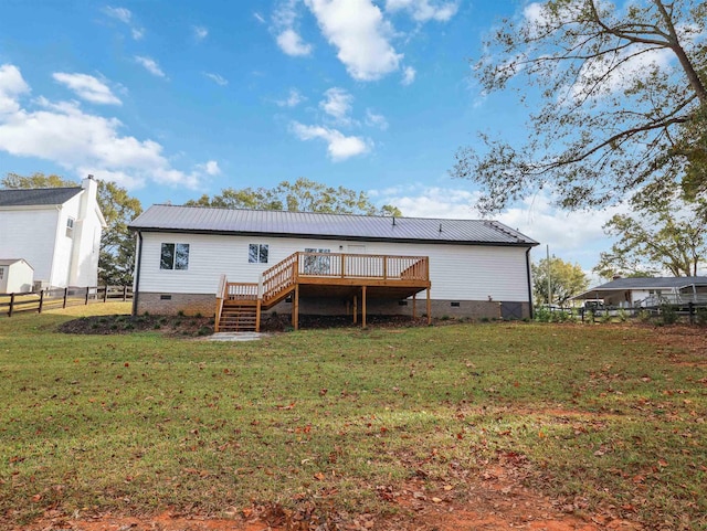 back of property featuring a yard and a deck