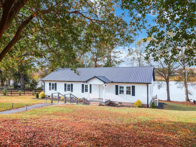 ranch-style house featuring a front yard and central AC