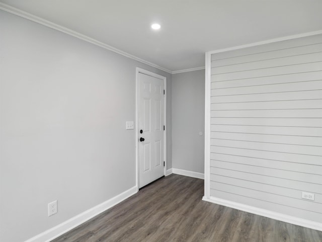 empty room with crown molding and dark wood-type flooring