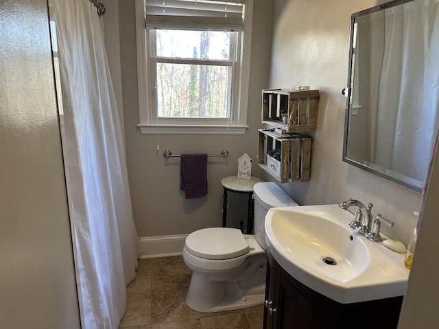 bathroom with tile patterned flooring, vanity, and toilet