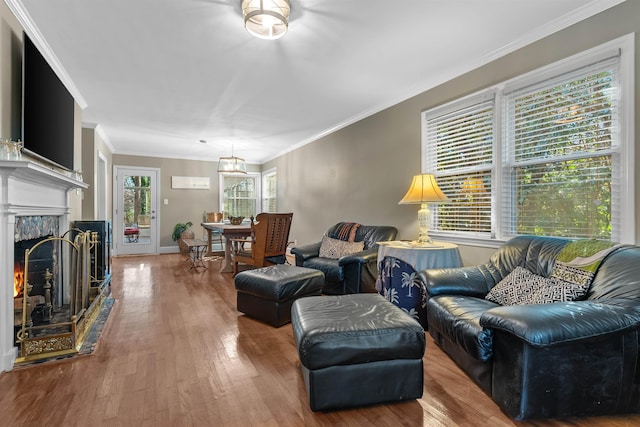 living room featuring hardwood / wood-style floors, an inviting chandelier, and crown molding