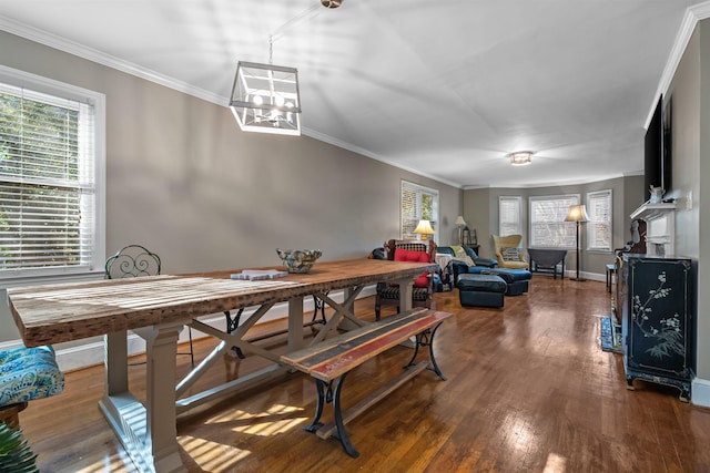 dining space featuring dark hardwood / wood-style floors, crown molding, and a notable chandelier