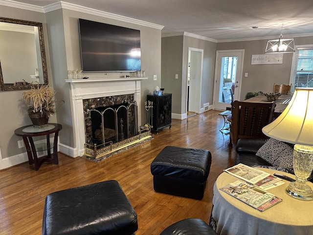 living room with hardwood / wood-style floors, a wealth of natural light, ornamental molding, and a premium fireplace