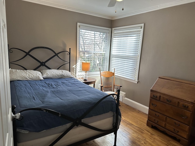 bedroom with crown molding, ceiling fan, and light wood-type flooring