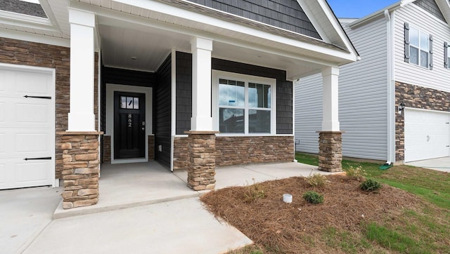 doorway to property with a garage and covered porch