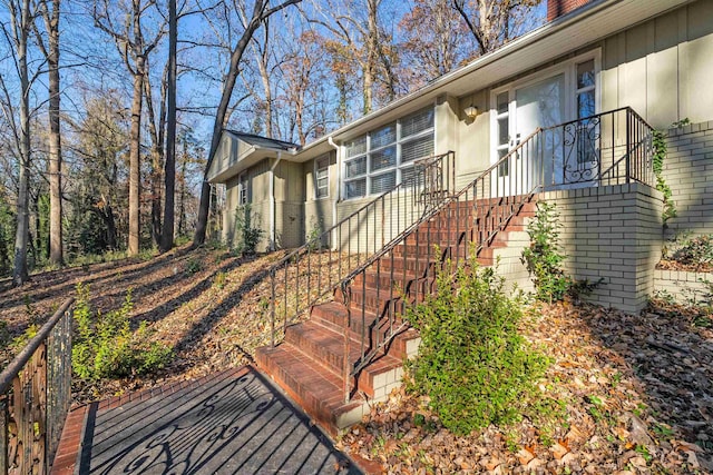 view of front of house with brick siding and stairway