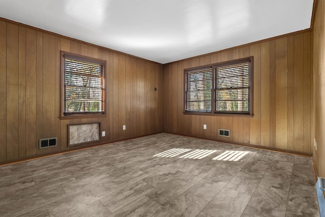 unfurnished room with plenty of natural light, visible vents, and baseboards