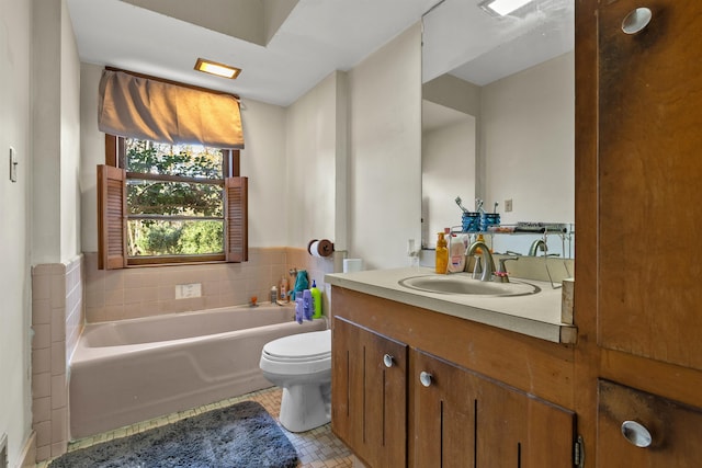 full bathroom featuring tile patterned flooring, a garden tub, vanity, and toilet