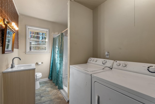 clothes washing area with sink and washer and dryer