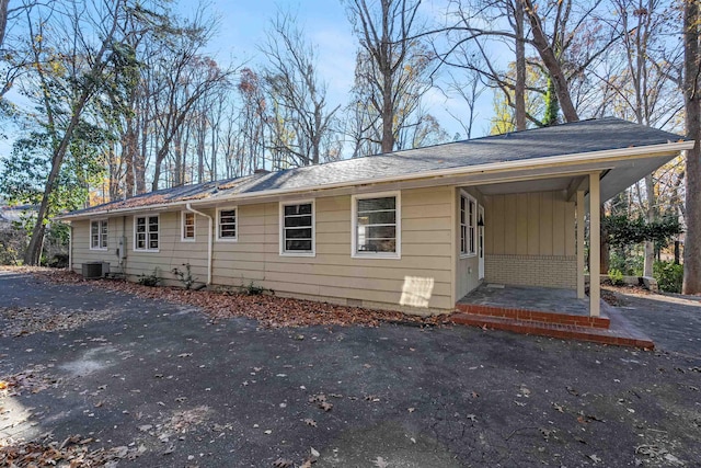 exterior space with cooling unit and brick siding