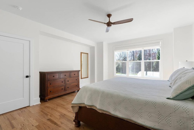 bedroom with ceiling fan and light hardwood / wood-style floors