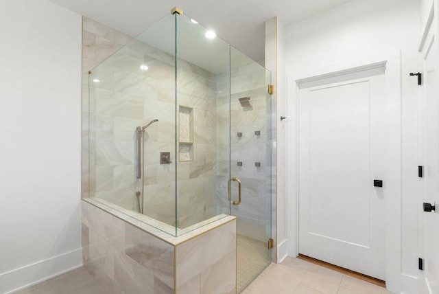 bathroom with tile patterned flooring and walk in shower