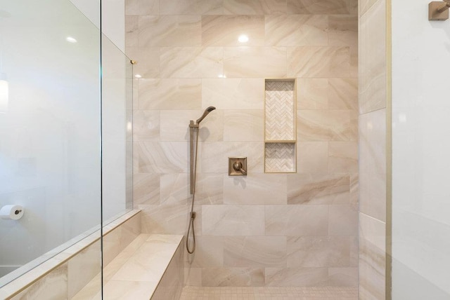 bathroom with a tile shower