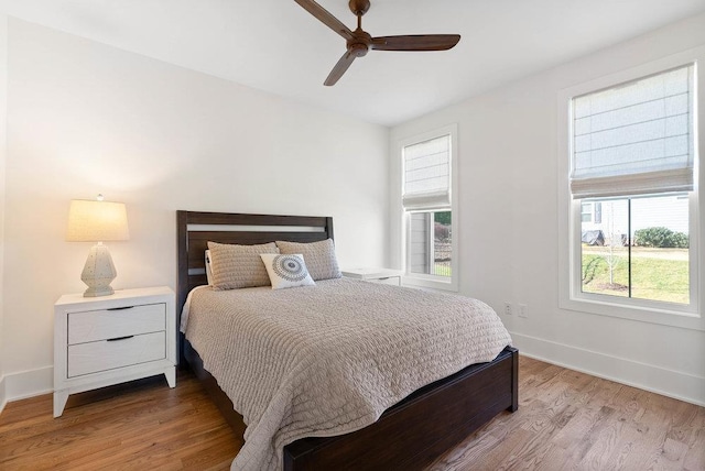 bedroom with hardwood / wood-style floors and ceiling fan