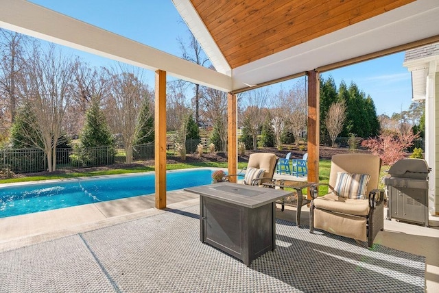 view of pool featuring a grill, a patio, and a fire pit