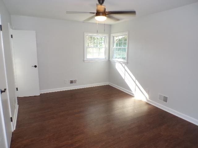 spare room with ceiling fan and dark wood-type flooring