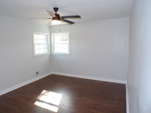 spare room with ceiling fan and dark hardwood / wood-style flooring