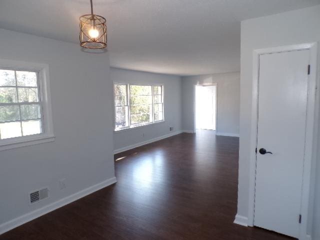 unfurnished room featuring dark hardwood / wood-style flooring