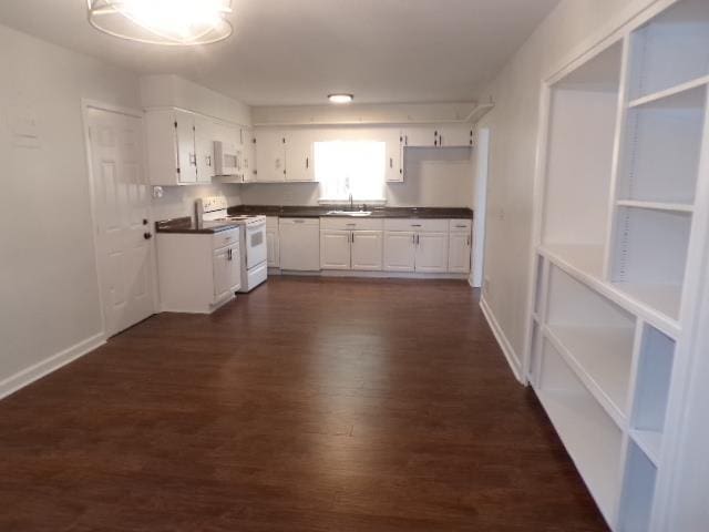 kitchen with white cabinets, dark hardwood / wood-style floors, white appliances, and sink