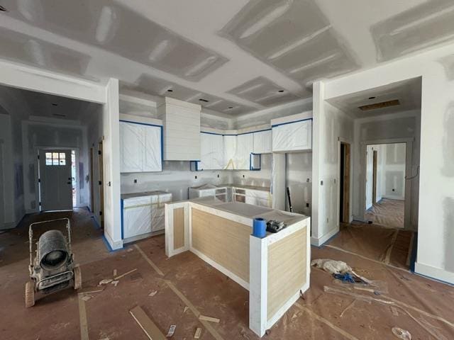 kitchen with white cabinetry and a center island