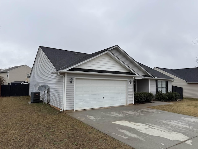 view of front facade with a front yard, central AC unit, and a garage