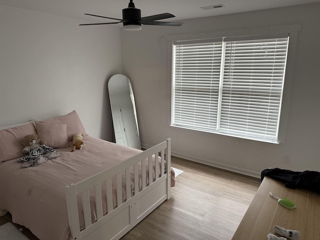 bedroom with ceiling fan and light wood-type flooring