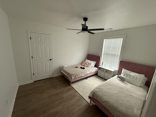 bedroom with ceiling fan and dark wood-type flooring