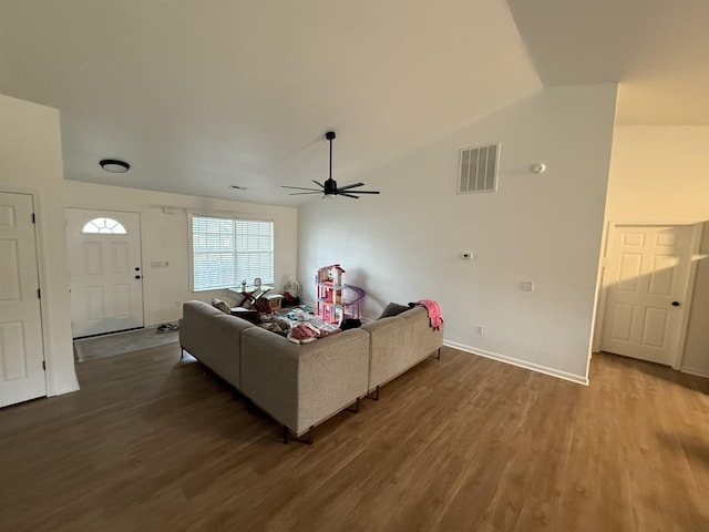 living room with ceiling fan, dark wood-type flooring, and lofted ceiling