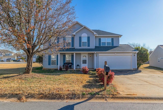 view of front of house featuring a front yard, a garage, and covered porch