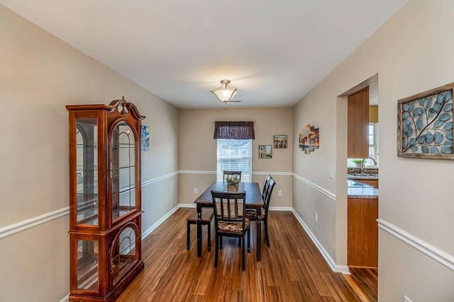 dining area featuring hardwood / wood-style floors and sink