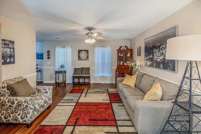 living room featuring dark hardwood / wood-style flooring and ceiling fan