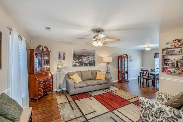 living room featuring dark hardwood / wood-style floors, plenty of natural light, and ceiling fan